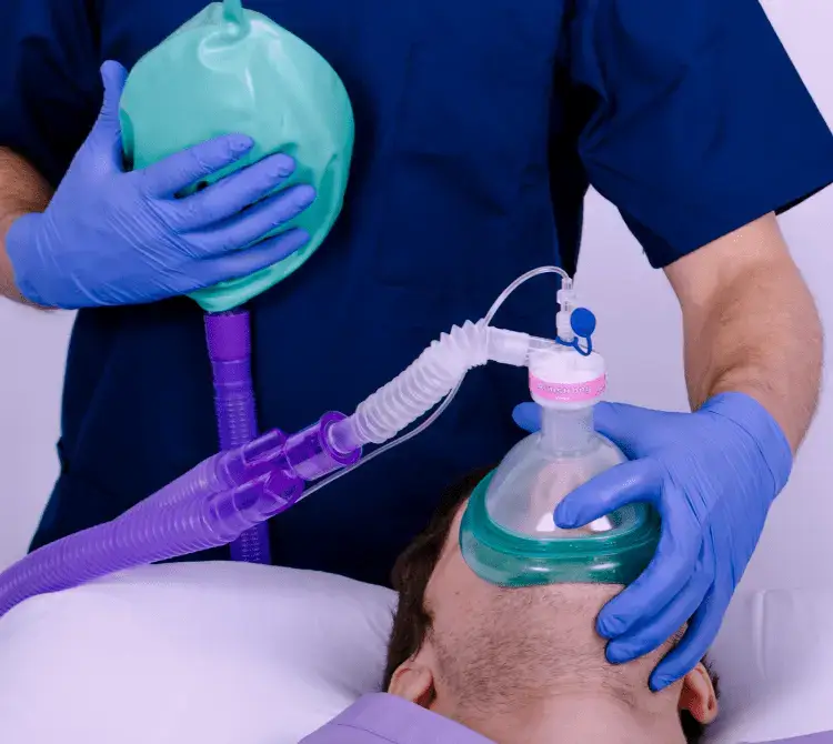 A patient receiving manual ventilation via the Mapleson C